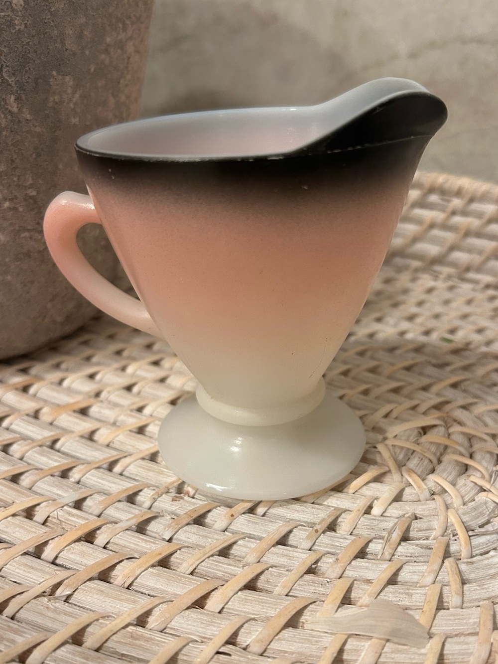 This is a vintage Hazel Atlas Ovide milk glass creamer in a pink and black ombre